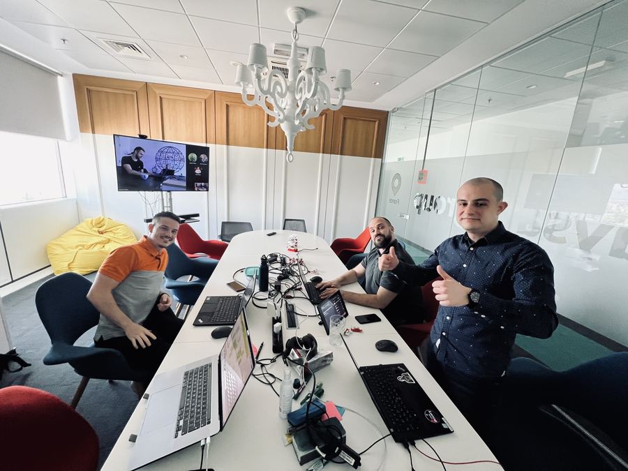 The team collaborating hybrid-style, on-site with remote teammates dialed in over Teams on the meeting room screen